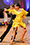 Erik and Rickie latin dance in yellow fringe dress.