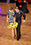 Erik and Rickie dancing Latin American ballroom dance. Rickie wears a black and white striped dress with yellow.