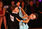 Young ballroom couple Erik and Rickie on dance floor. International Standard.